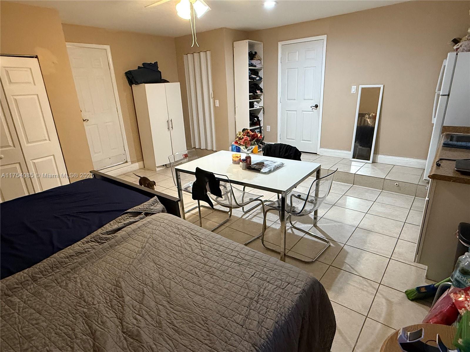 16618 Southwest 68th Terrace Miami, FL 33193 - Photo 33 of 34 a bedroom with a bed and a table in it