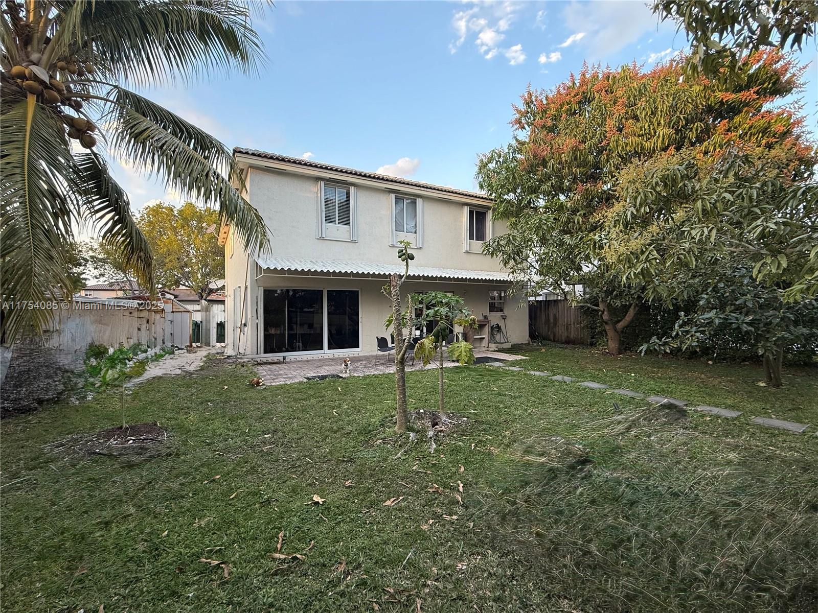 16618 Southwest 68th Terrace Miami, FL 33193 - Photo 4 of 34 a front view of a house with a garden