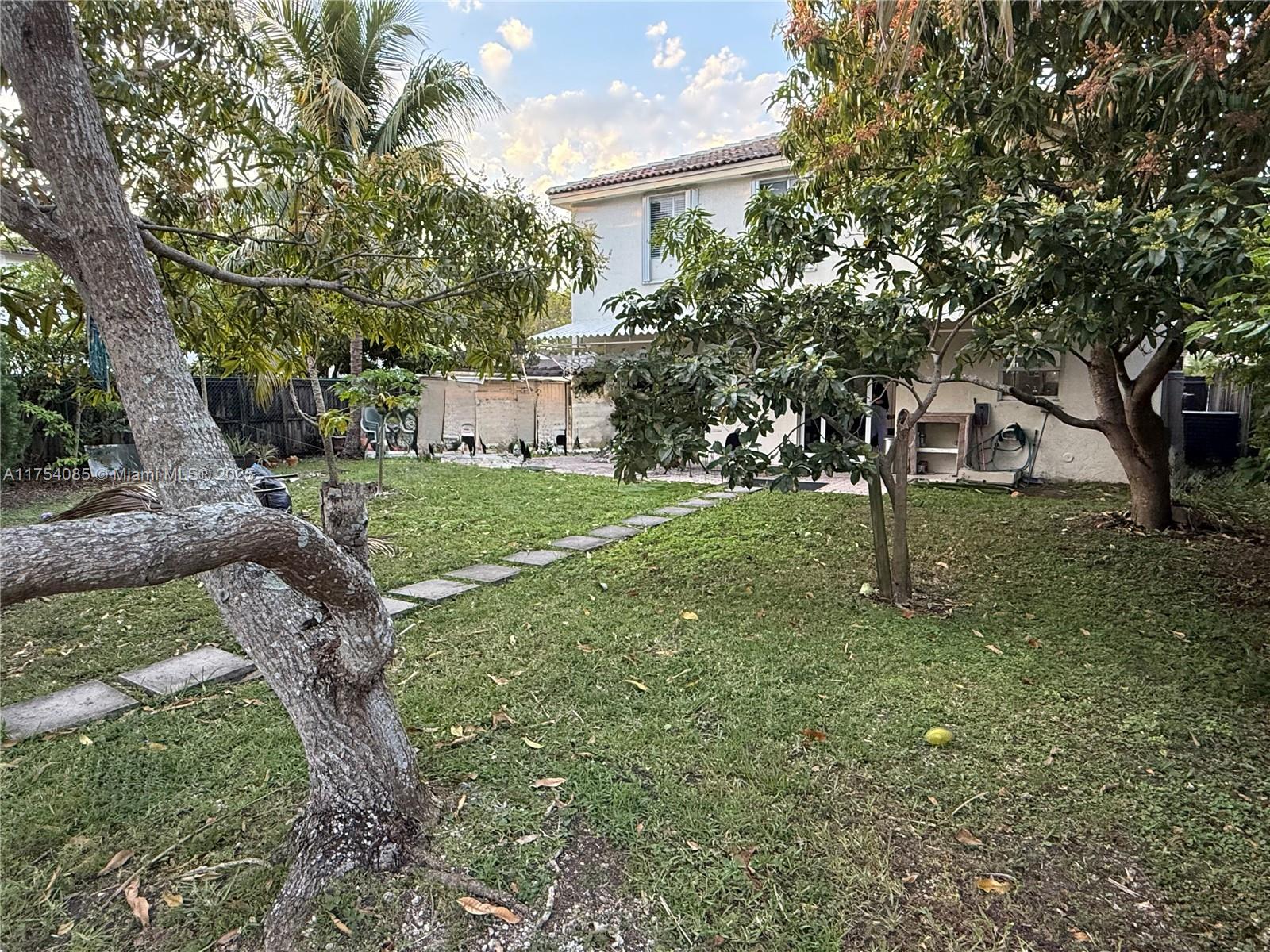 16618 Southwest 68th Terrace Miami, FL 33193 - Photo 5 of 34 a front view of a house with a yard