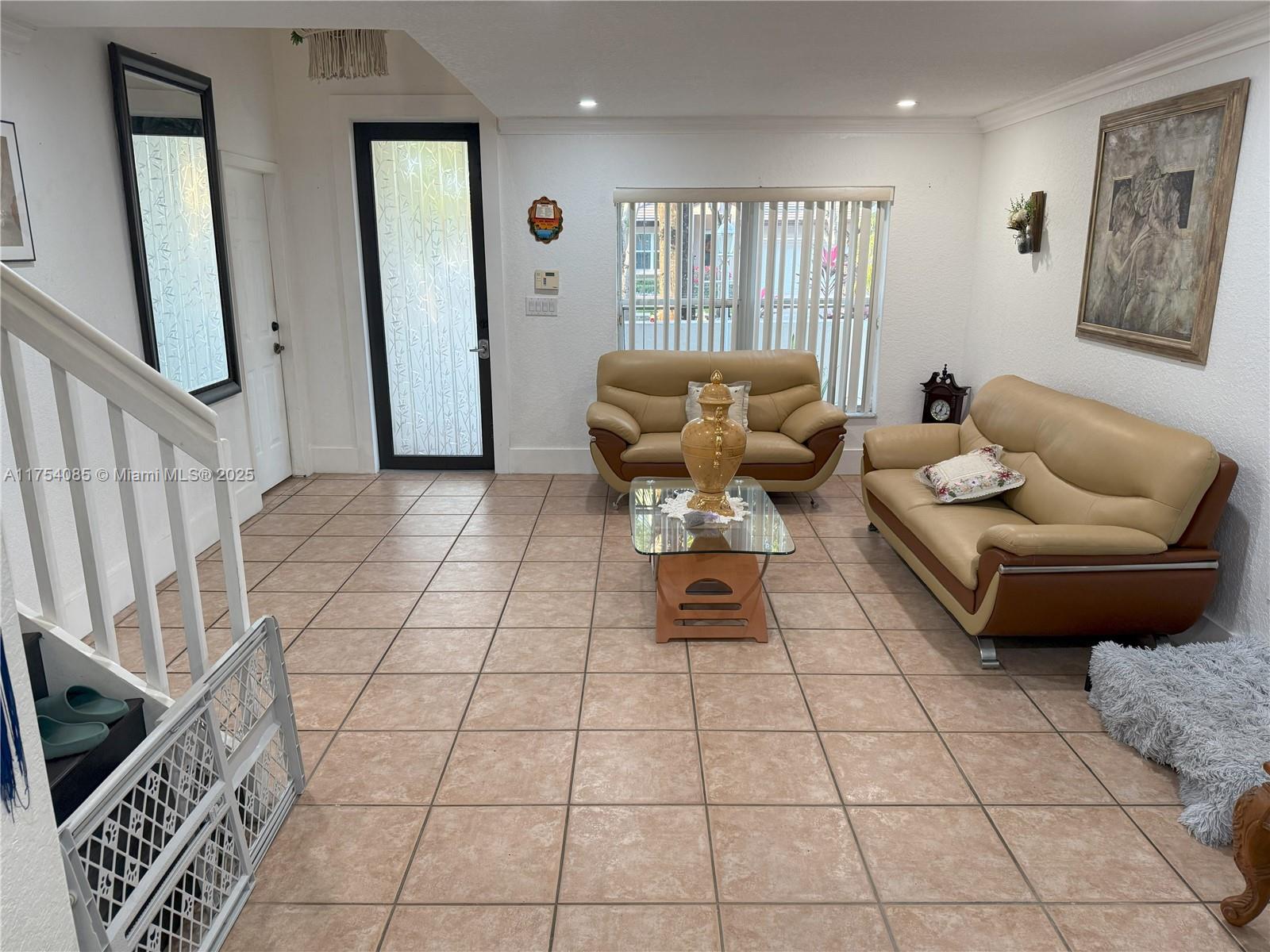 16618 Southwest 68th Terrace Miami, FL 33193 - Photo 10 of 34 a living room with furniture and a rug