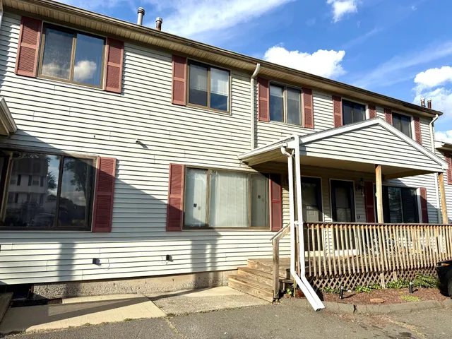 a view of a house with a small deck
