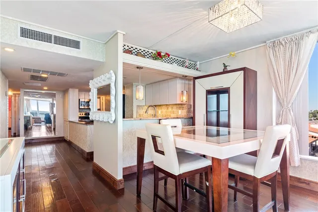 a kitchen with appliances a microwave and cabinets