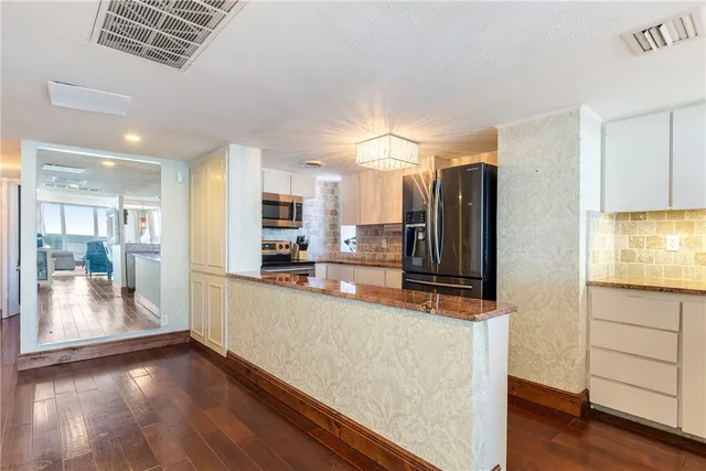 a kitchen with granite countertop a sink and a stove