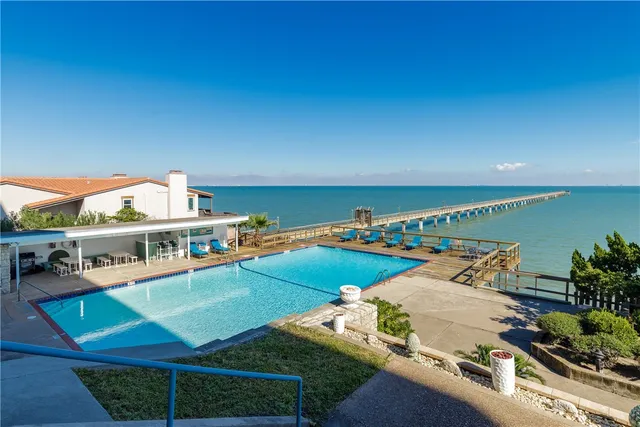 a view of a swimming pool and an outdoor seating