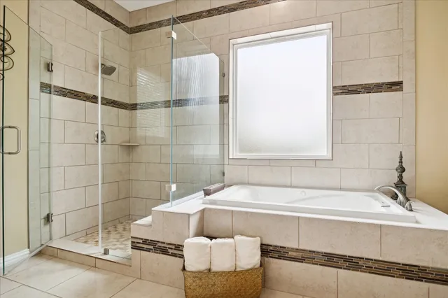 a bathroom with a bathtub and shower