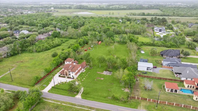 an aerial view of residential houses with outdoor space and street view