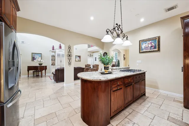 a view of a kitchen with granite countertop a sink a counter top space and living room view