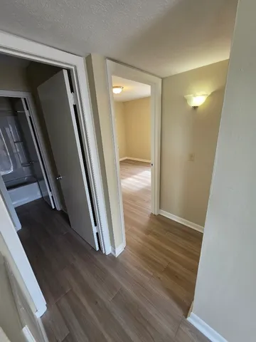 a view of a hallway view with wooden floor