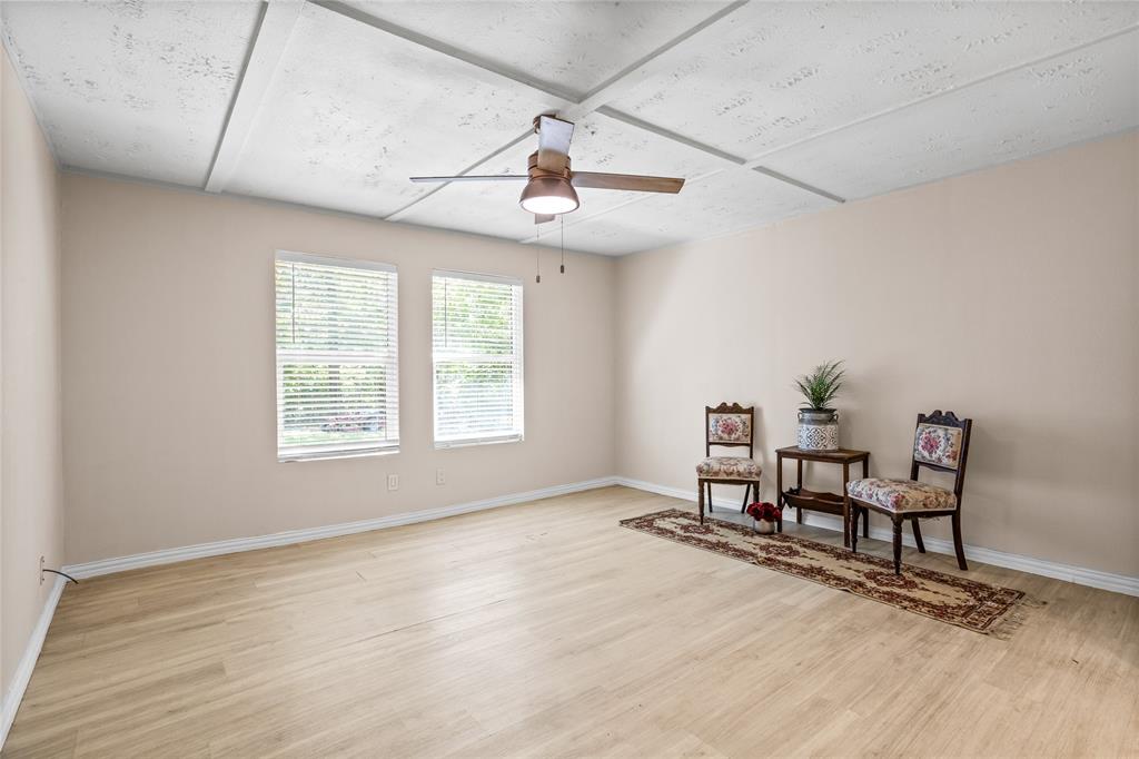 614 Rice Street Denison, TX 75020 - Photo 16 of 22 At the other end of the house and just off the kitchen, you will find the largest bedroom which is at the back of the home. It also has a very large closet.