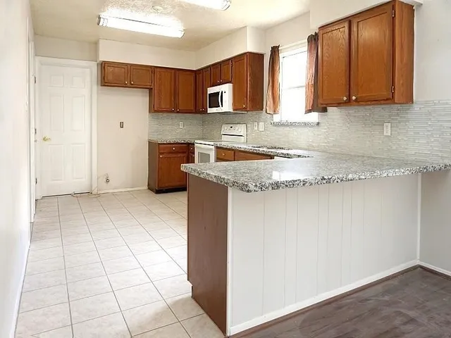 a kitchen with a stove a sink and a refrigerator