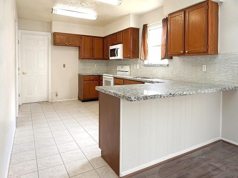 16210 Cypress Point Drive Cypress, TX 77429 - Photo 2 of 10 a kitchen with a stove a sink and a refrigerator