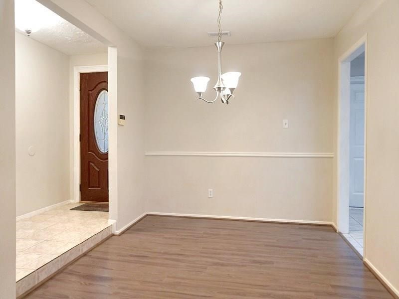 16210 Cypress Point Drive Cypress, TX 77429 - Photo 3 of 10 wooden floor in an empty room with a window