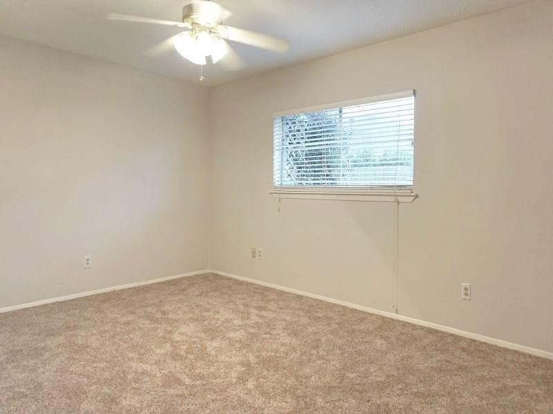 16210 Cypress Point Drive Cypress, TX 77429 - Photo 5 of 10 an empty room with a window and a fan