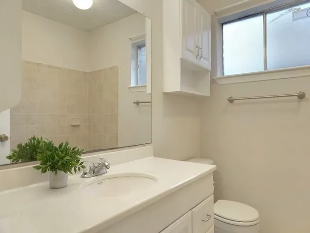 a bathroom with a sink a toilet and tub