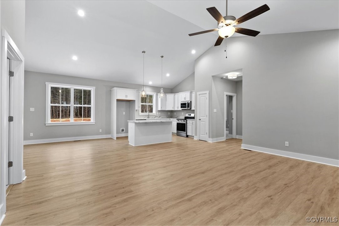 292 Lunenburg County Road Keysville, VA 23947 - Photo 13 of 39 Unfurnished living room featuring ceiling fan, sin