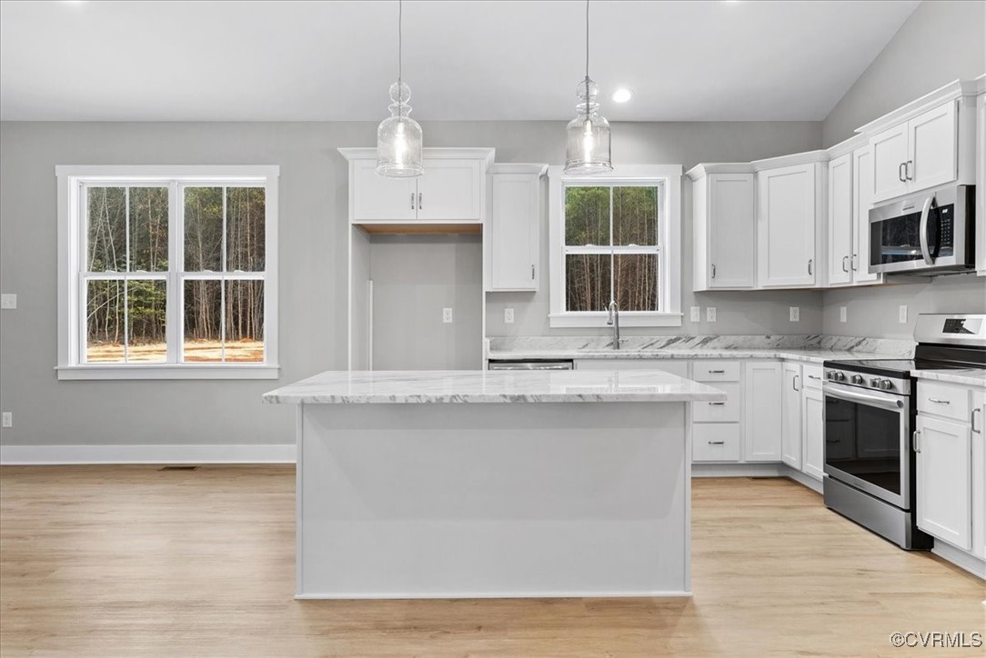 292 Lunenburg County Road Keysville, VA 23947 - Photo 14 of 39 Kitchen with decorative light fixtures, white cabi