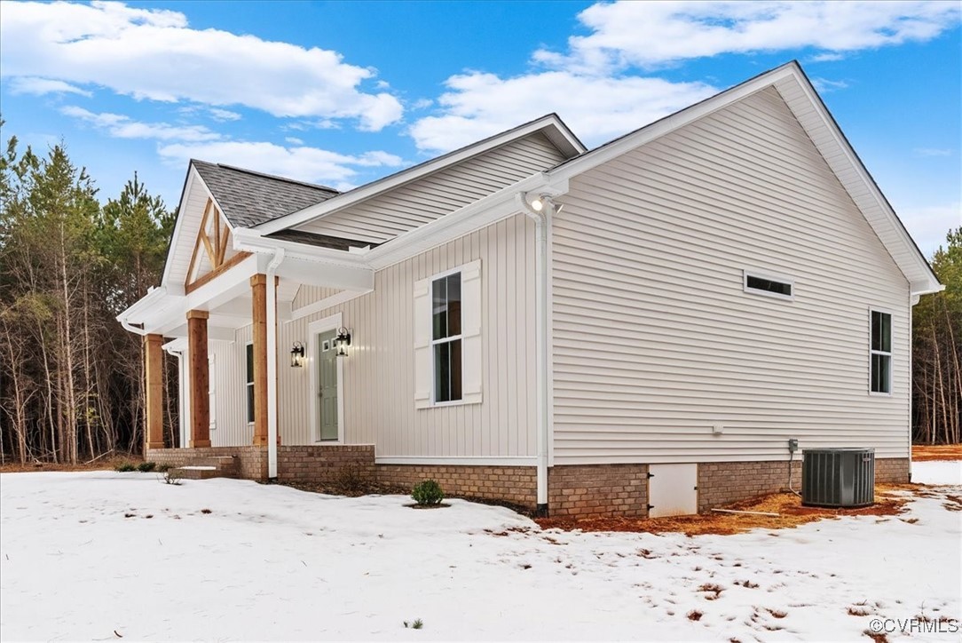 292 Lunenburg County Road Keysville, VA 23947 - Photo 2 of 39 View of snow covered exterior featuring cooling un