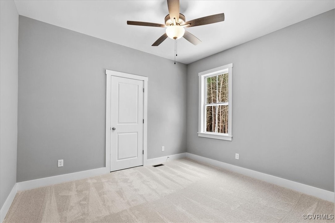 292 Lunenburg County Road Keysville, VA 23947 - Photo 34 of 39 Carpeted empty room with ceiling fan