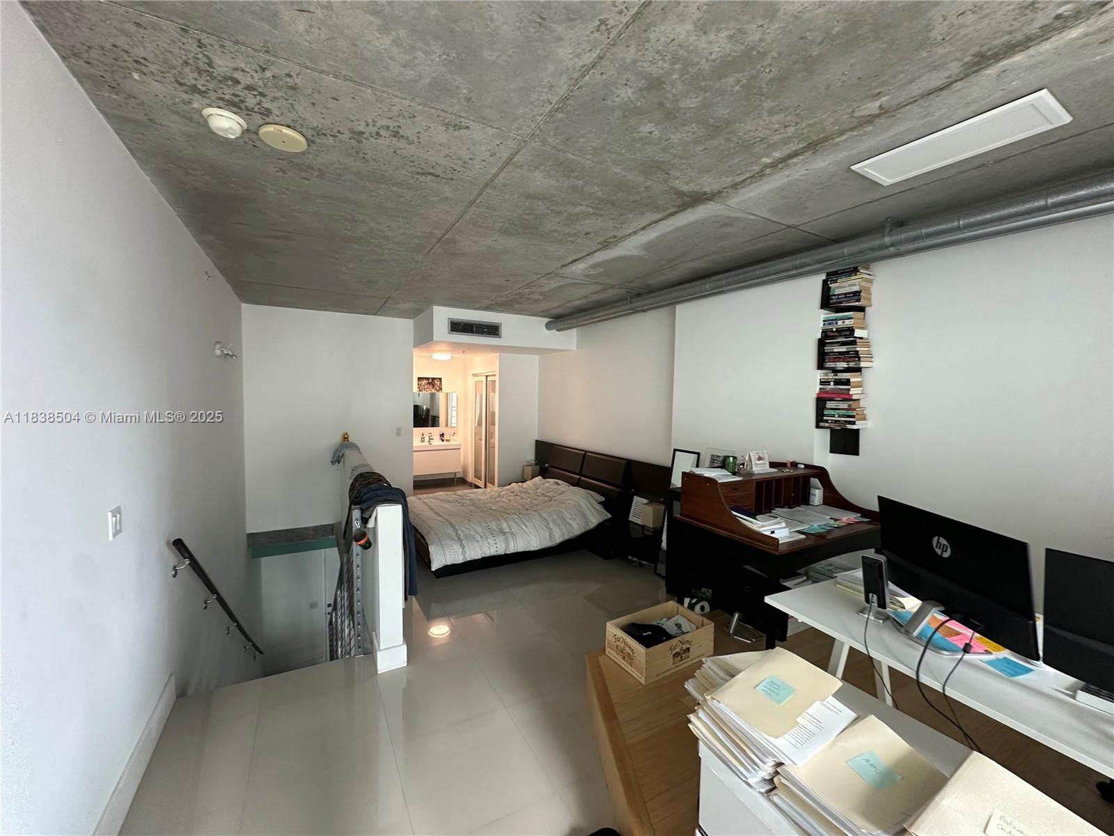 690 Southwest 1st Court, Unit 1010 Miami, FL 33130 - Photo 11 of 11 a living room with furniture and a flat screen tv