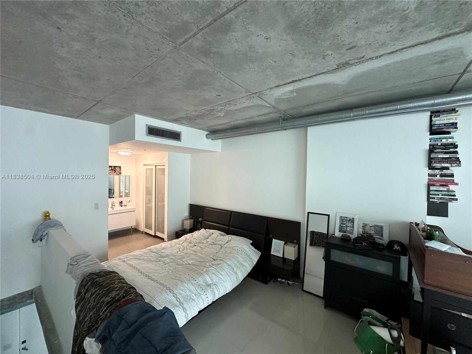 690 Southwest 1st Court, Unit 1010 Miami, FL 33130 - Photo 7 of 11 a bedroom with a bed and wooden floor