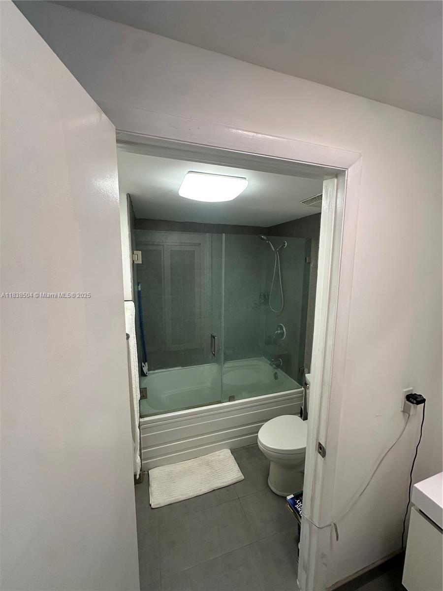 690 Southwest 1st Court, Unit 1010 Miami, FL 33130 - Photo 9 of 11 a bathroom with a shower and a toilet