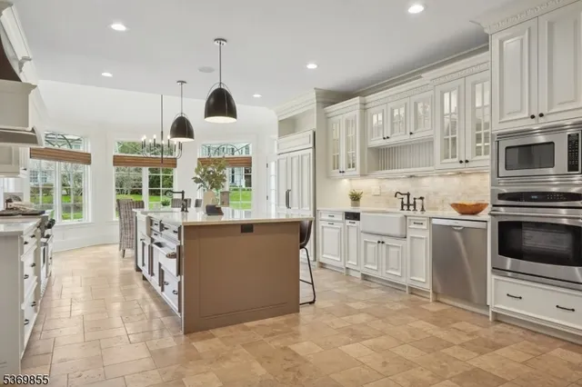 a kitchen with stainless steel appliances kitchen island granite countertop a sink and cabinets