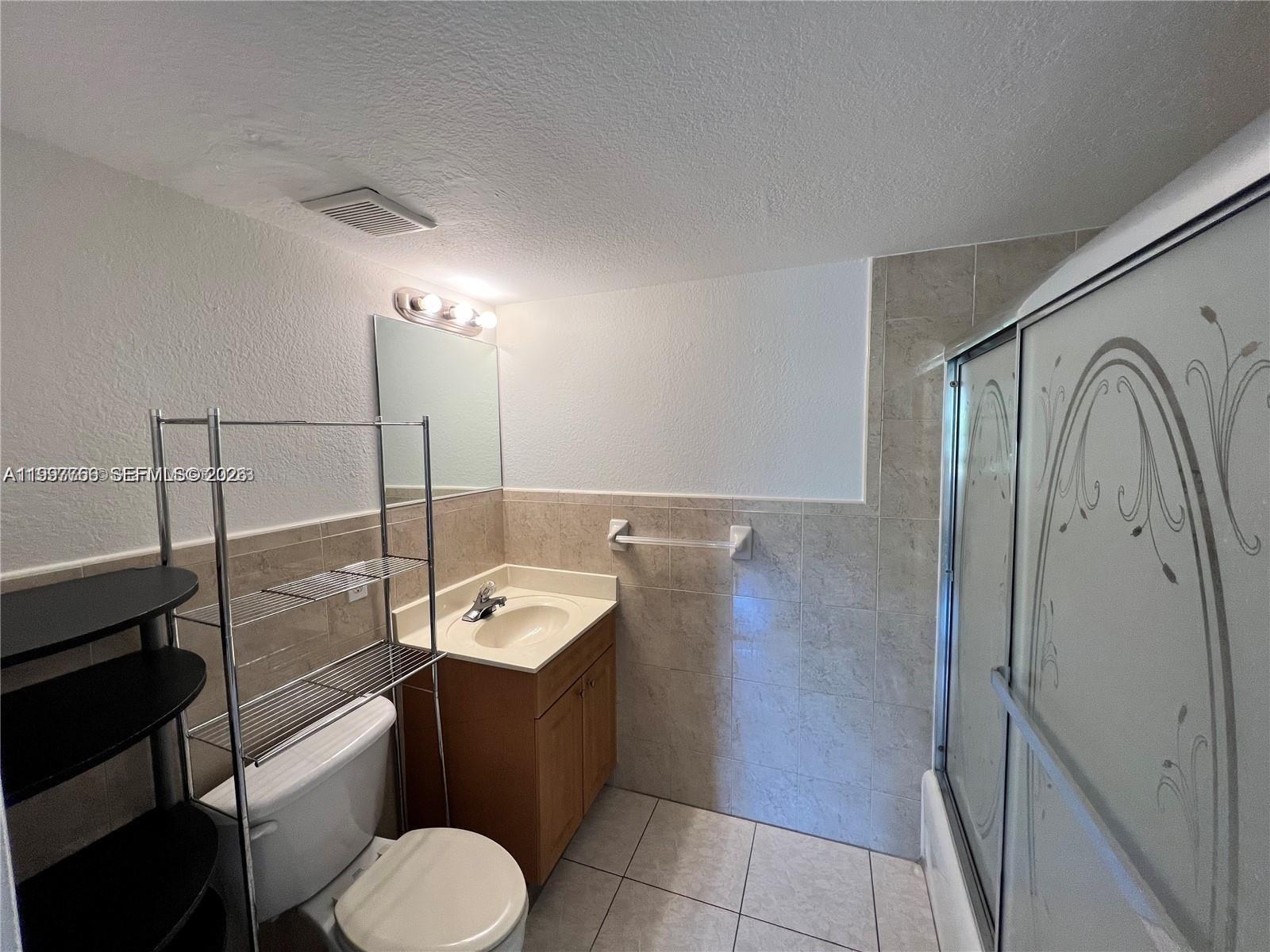 637 Southwest 3rd Street, Unit 306 Miami, FL 33130 - Photo 11 of 19 a bathroom with a toilet sink and mirror