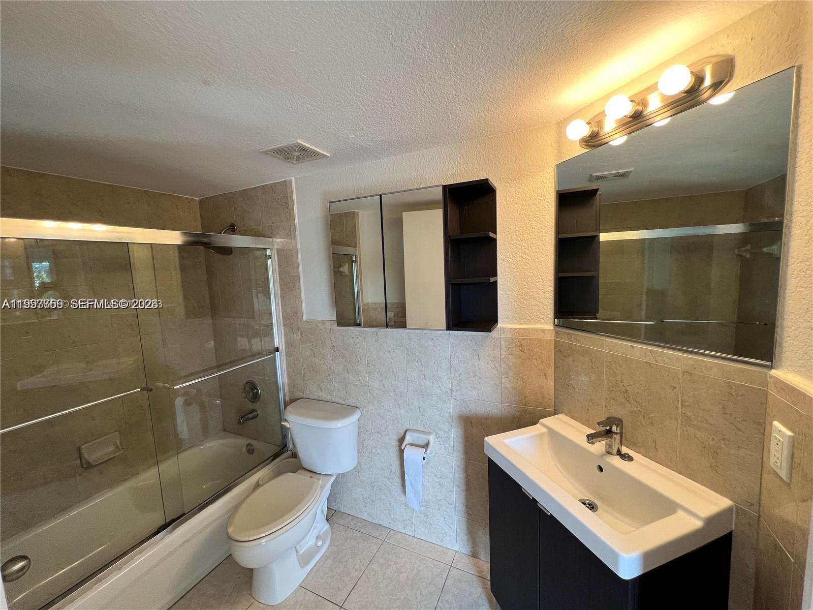 637 Southwest 3rd Street, Unit 306 Miami, FL 33130 - Photo 12 of 19 a bathroom with a sink toilet a mirror and shower