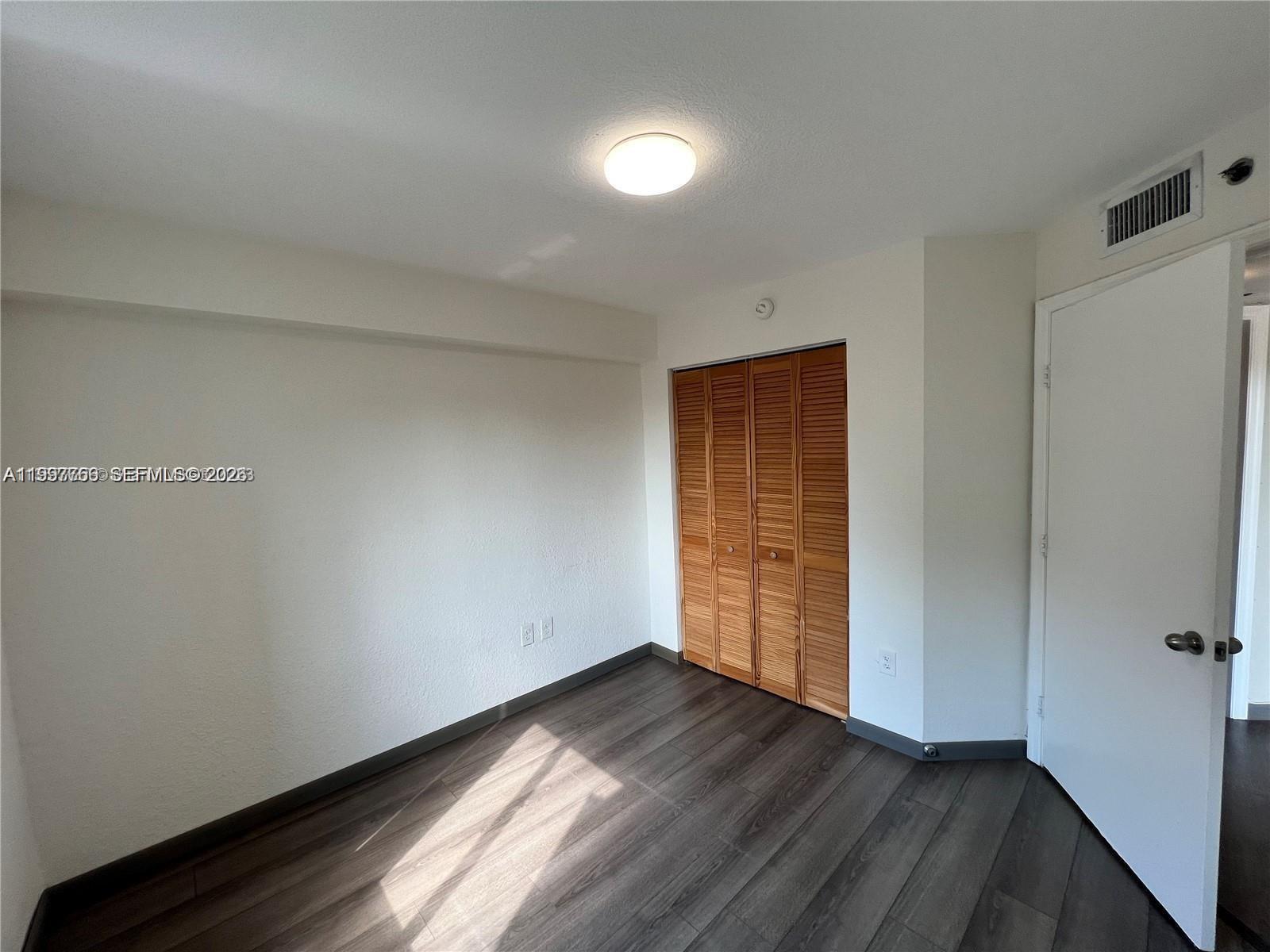 637 Southwest 3rd Street, Unit 306 Miami, FL 33130 - Photo 14 of 19 wooden floor in an empty room