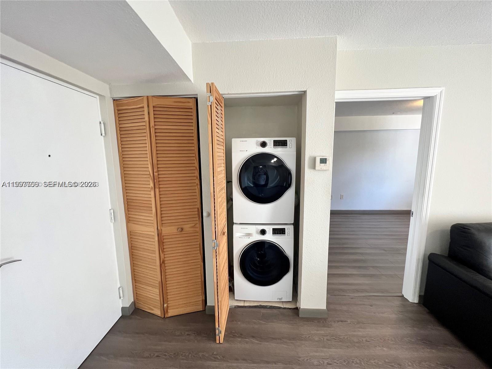 637 Southwest 3rd Street, Unit 306 Miami, FL 33130 - Photo 15 of 19 a view of a hallway with washer and dryer
