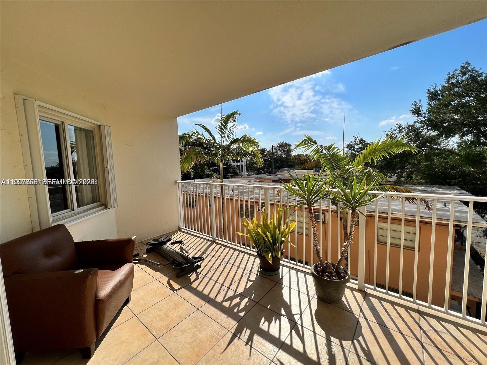 637 Southwest 3rd Street, Unit 306 Miami, FL 33130 - Photo 16 of 19 a view of balcony with wooden floor and outdoor seating