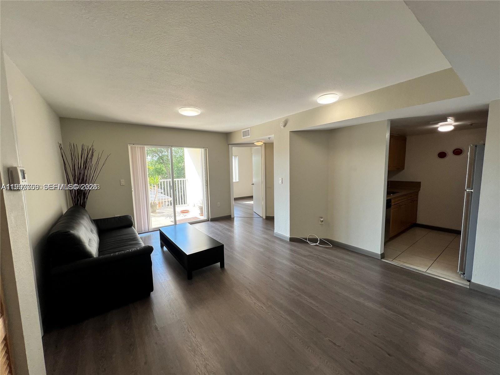637 Southwest 3rd Street, Unit 306 Miami, FL 33130 - Photo 3 of 19 a living room with furniture and wooden floor