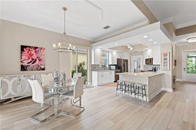 a large kitchen with kitchen island a large counter top space and stainless steel appliances