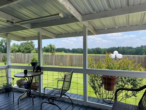 a view of a chairs and table in patio