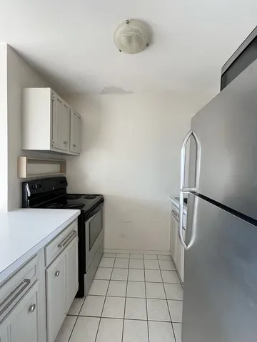 a kitchen with a sink a stove and cabinets
