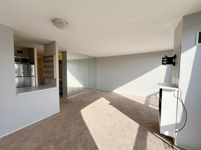 a view of staircase with white walls and glass door