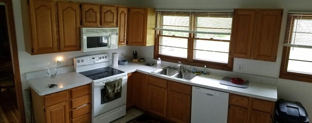 10543 East Flagg Road Rochelle, IL 61068 - Photo 4 of 17 a kitchen with stainless steel appliances granite countertop a sink stove and microwave