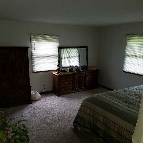 10543 East Flagg Road Rochelle, IL 61068 - Photo 6 of 17 a bed sitting in a bedroom next to a window