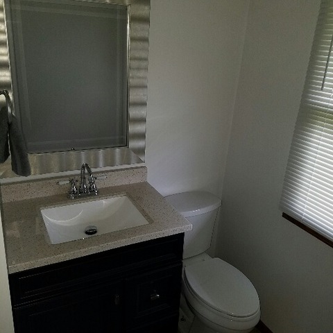 10543 East Flagg Road Rochelle, IL 61068 - Photo 7 of 17 a bathroom with a sink toilet and mirror