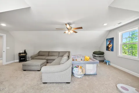 a bedroom with furniture and a large window