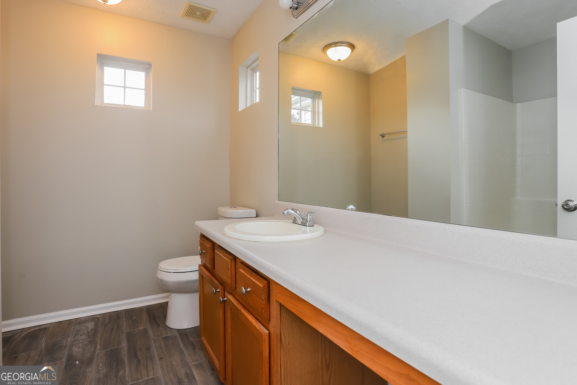 688 Windcroft Circle Northwest Acworth, GA 30101 - Photo 11 of 17 a bathroom with a sink a toilet and a mirror
