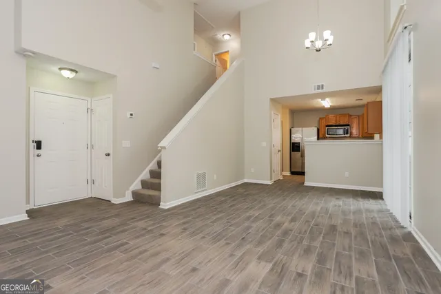 wooden floor in an empty room with wooden floor and staircase