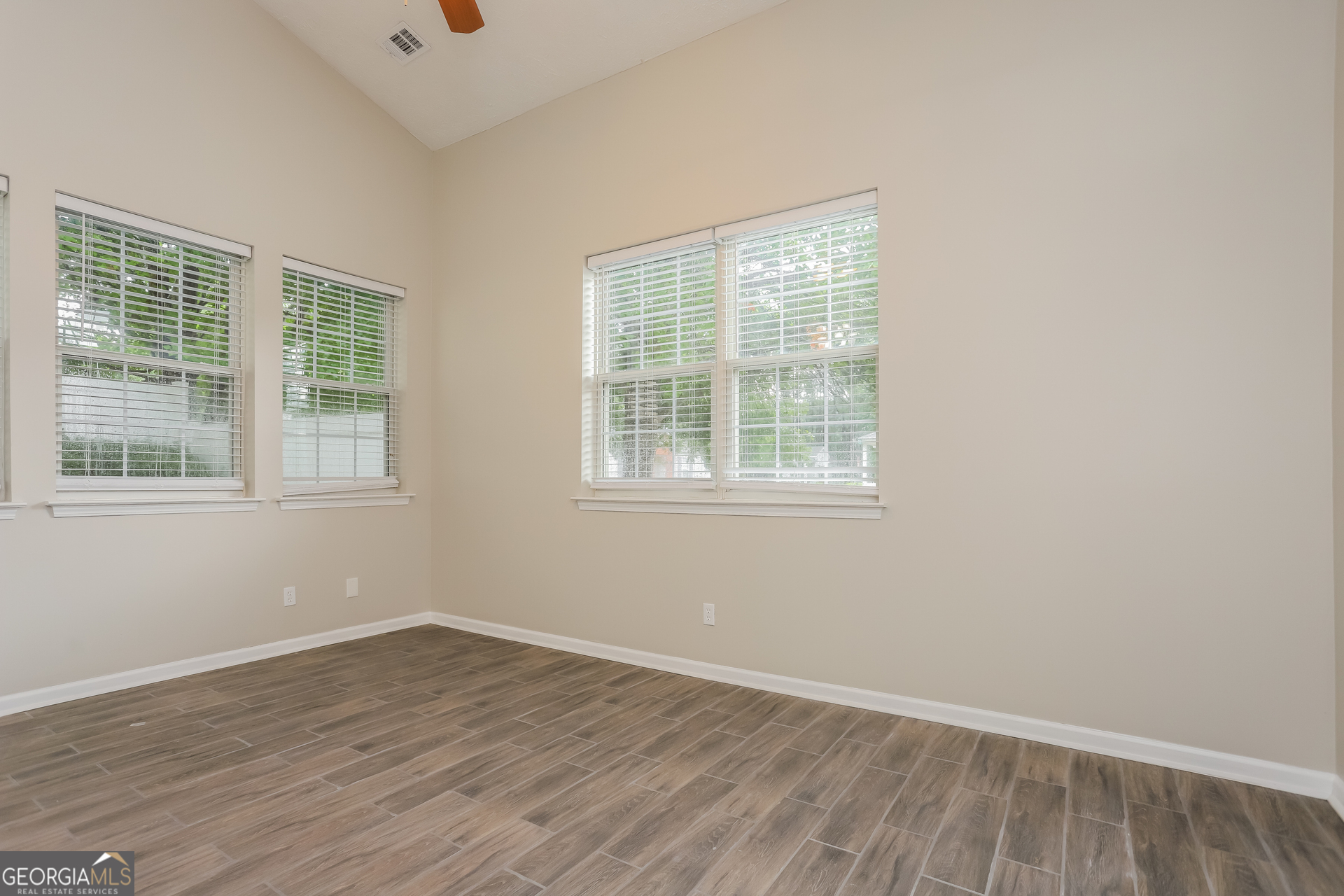 688 Windcroft Circle Northwest Acworth, GA 30101 - Photo 3 of 17 an empty room with wooden floor and windows