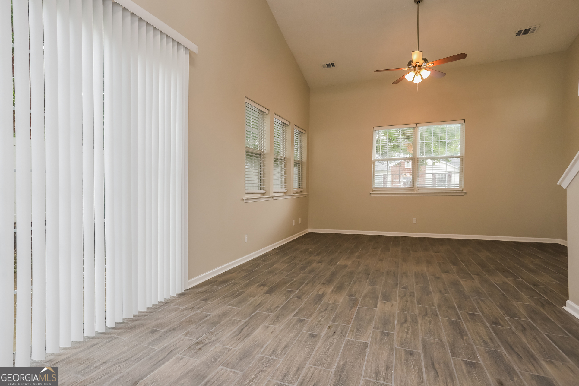688 Windcroft Circle Northwest Acworth, GA 30101 - Photo 5 of 17 an empty room with wooden floor and windows