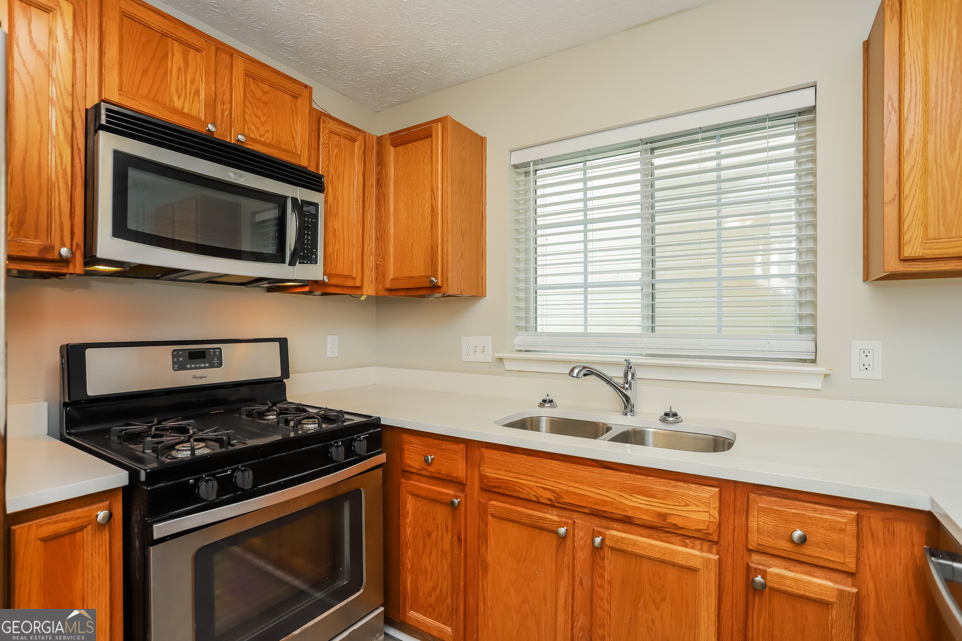 688 Windcroft Circle Northwest Acworth, GA 30101 - Photo 8 of 17 a kitchen with stainless steel appliances a stove a microwave and sink