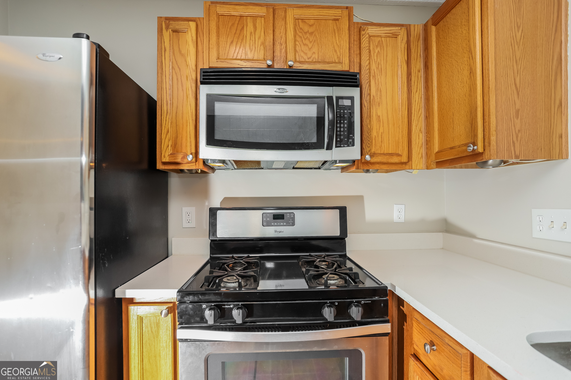 688 Windcroft Circle Northwest Acworth, GA 30101 - Photo 9 of 17 a kitchen with granite countertop a stove and a microwave