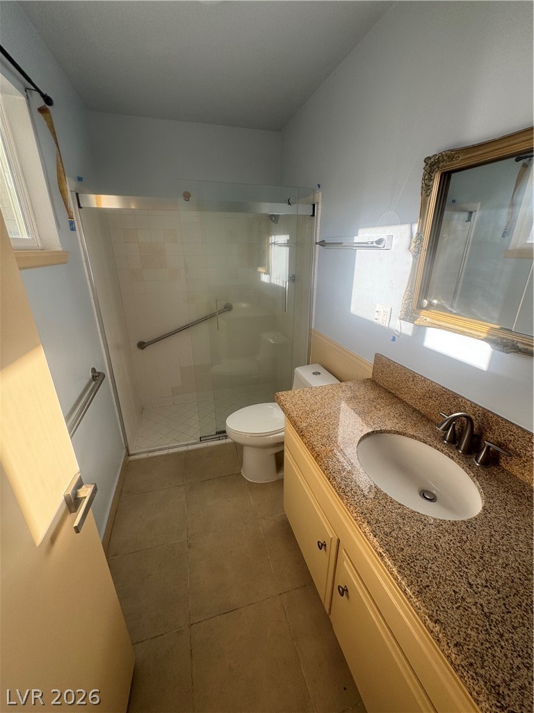 4420 Del Monte Avenue, Unit RENTAL Las Vegas, NV 89102 - Photo 16 of 20 A compact bathroom featuring a sleek walk-in shower and a vanity with a granite countertop.