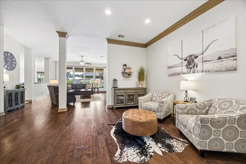 a living room with furniture and wooden floor