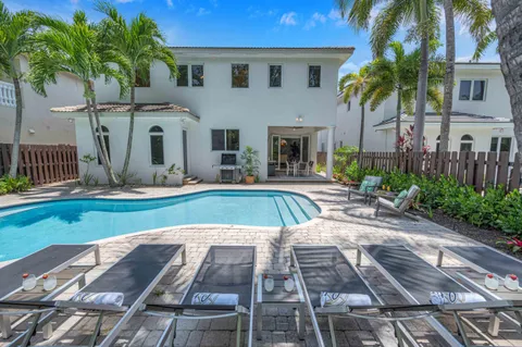a view of yard with swimming pool and furniture