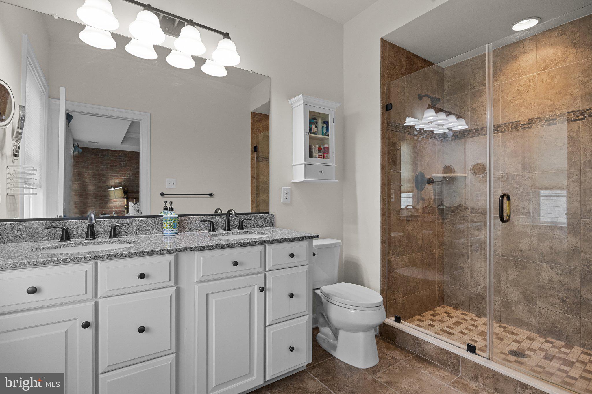3842 Jacob Stout Road Doylestown, PA 18902 - Photo 20 of 68 a bathroom with a granite countertop sink a toilet and a mirror